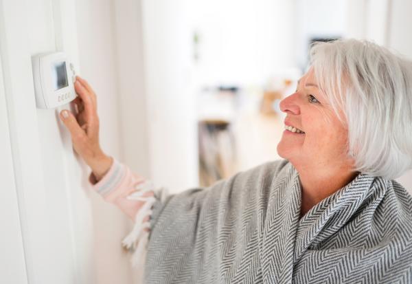 lady changing a thermostat