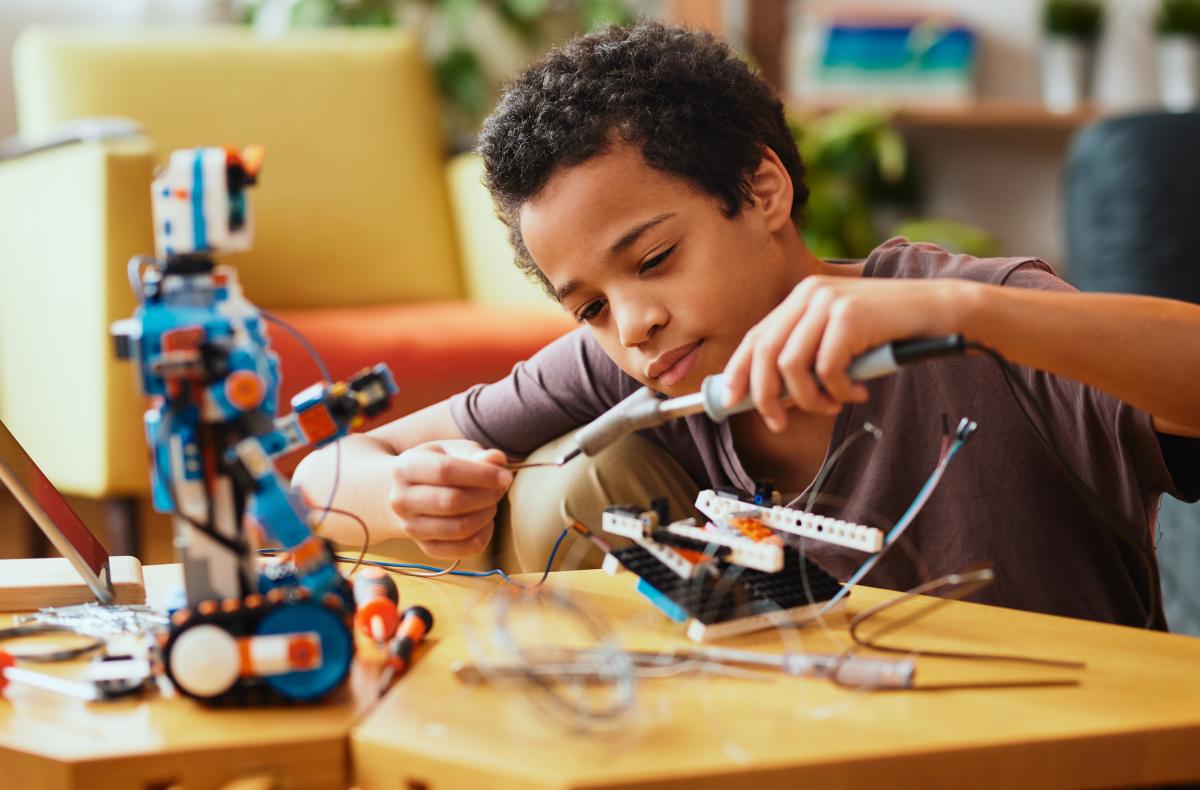 Young boy working on a robot