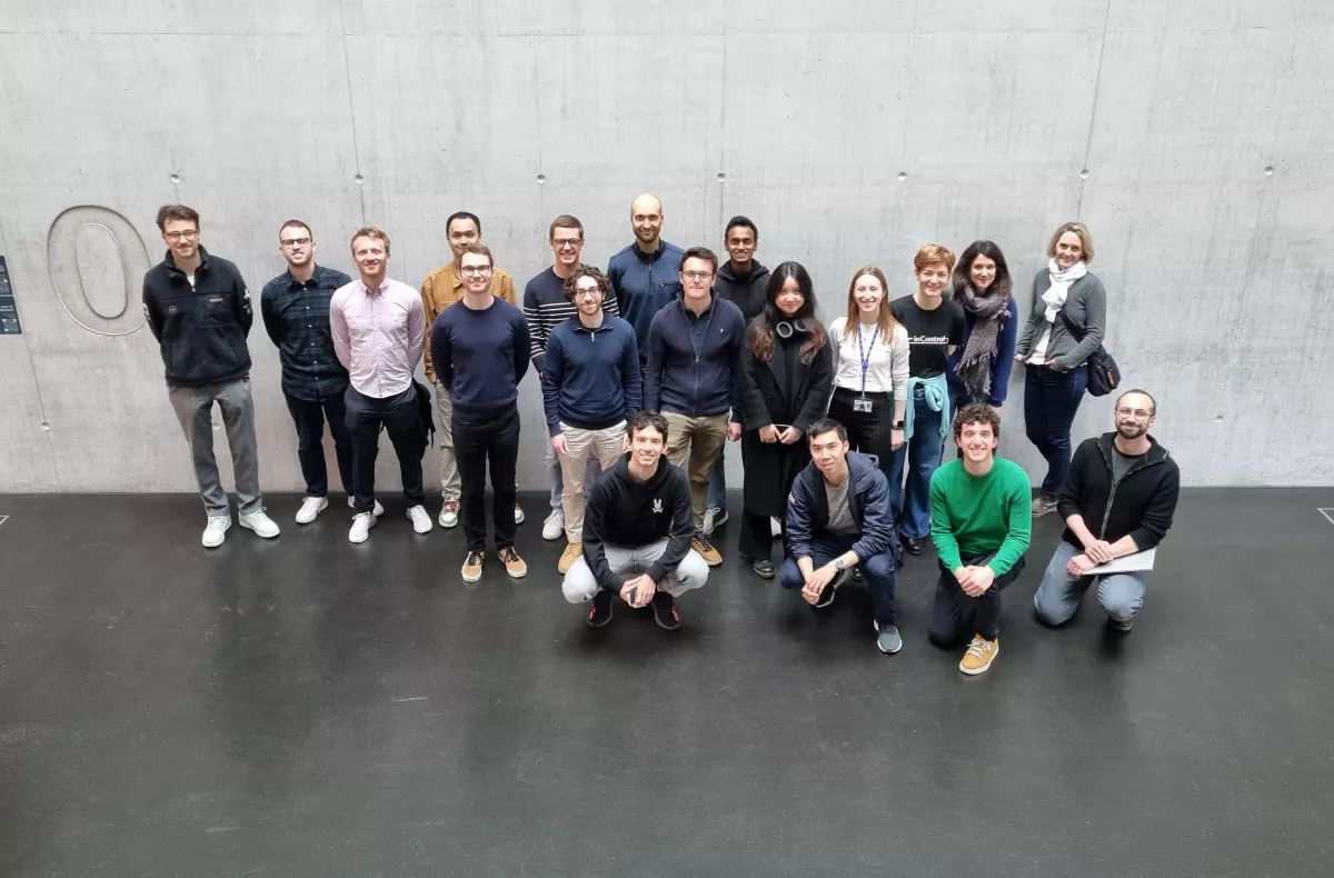 Group of fellowship holders standing in the entrance of the Empa NEST building