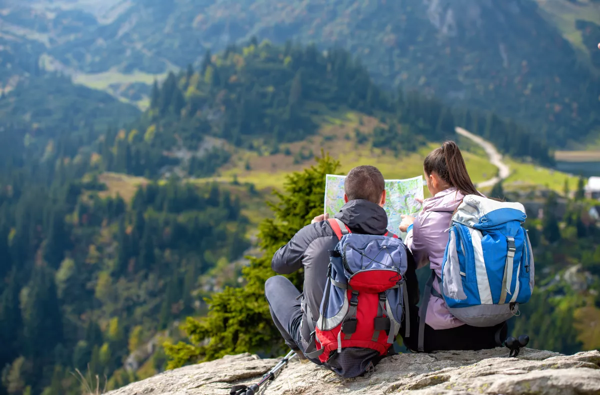 Two people looking at a map, deciding which path to take
