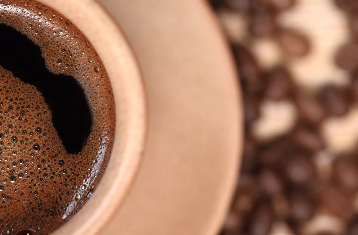 Coffee cup with bubbles swirling on the surface