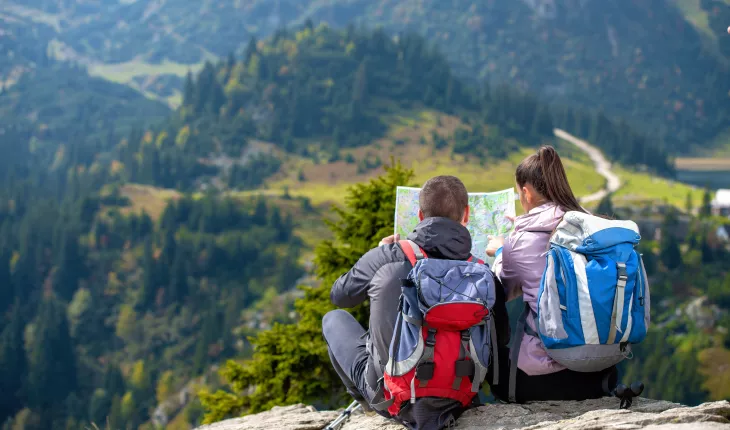Two people looking at a map, deciding which path to take