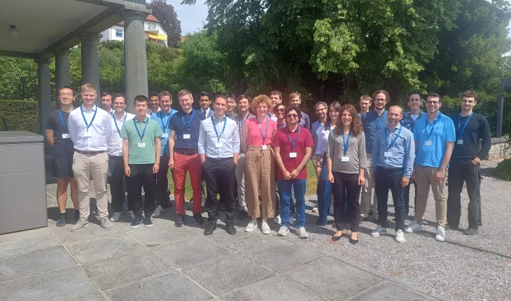 All the workshop participants stand in a group outside Zurich's Villa Hatt