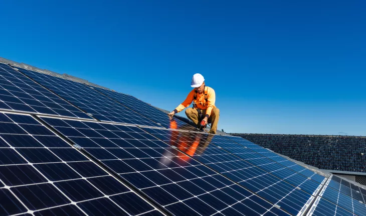 A man fixing solar panels