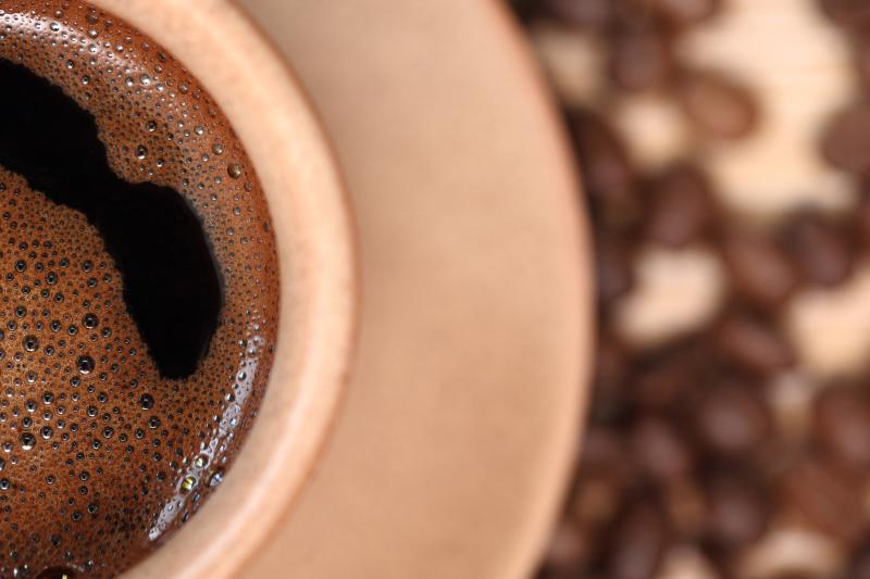 Coffee cup with bubbles swirling on the surface